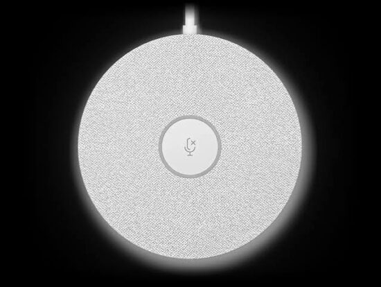 Round smart speaker with a textured white surface, top power cable, and a centered muted microphone icon.