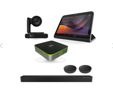 Camera on a stand, a tablet display, a green-trim streaming box, two small round speakers, and a long soundbar.