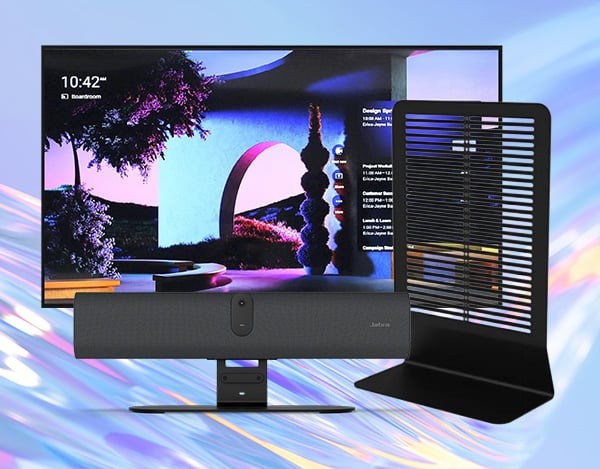 Desktop computer setup with a large monitor displaying colorful wallpaper, a soundbar with a central webcam in front, and a tall freestanding vented device on the right.