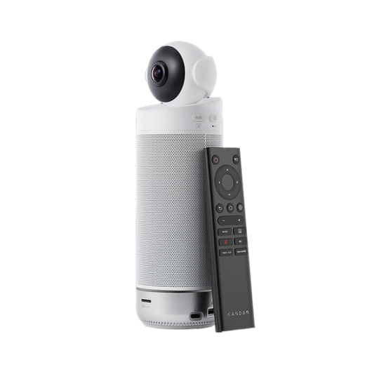All-in-one video conferencing device: a tall silver speaker with a top-mounted camera and a black remote resting beside.